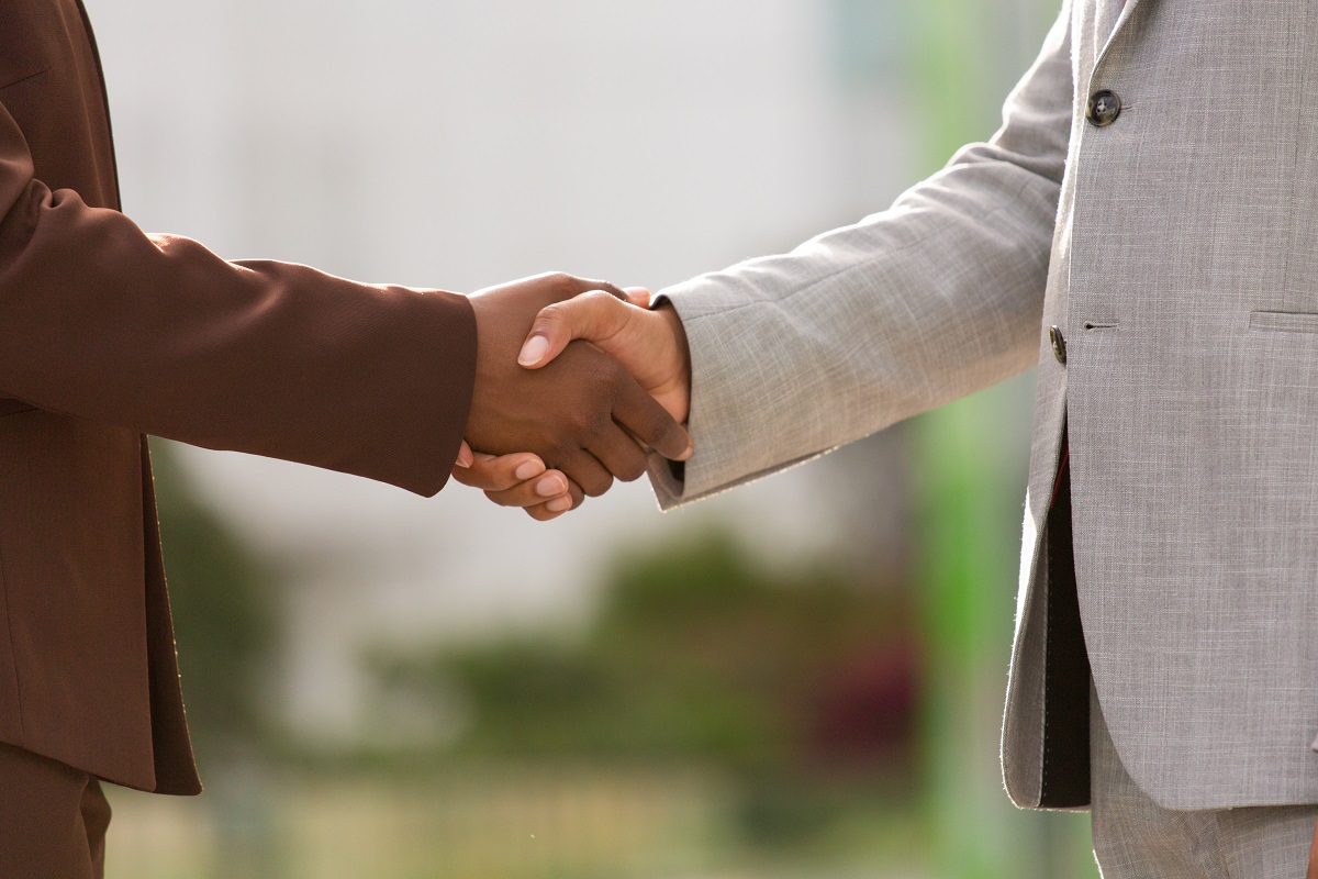 Successful business partners closing deal. Closeup of multiethnic businesspeople shaking hands Handshake concept