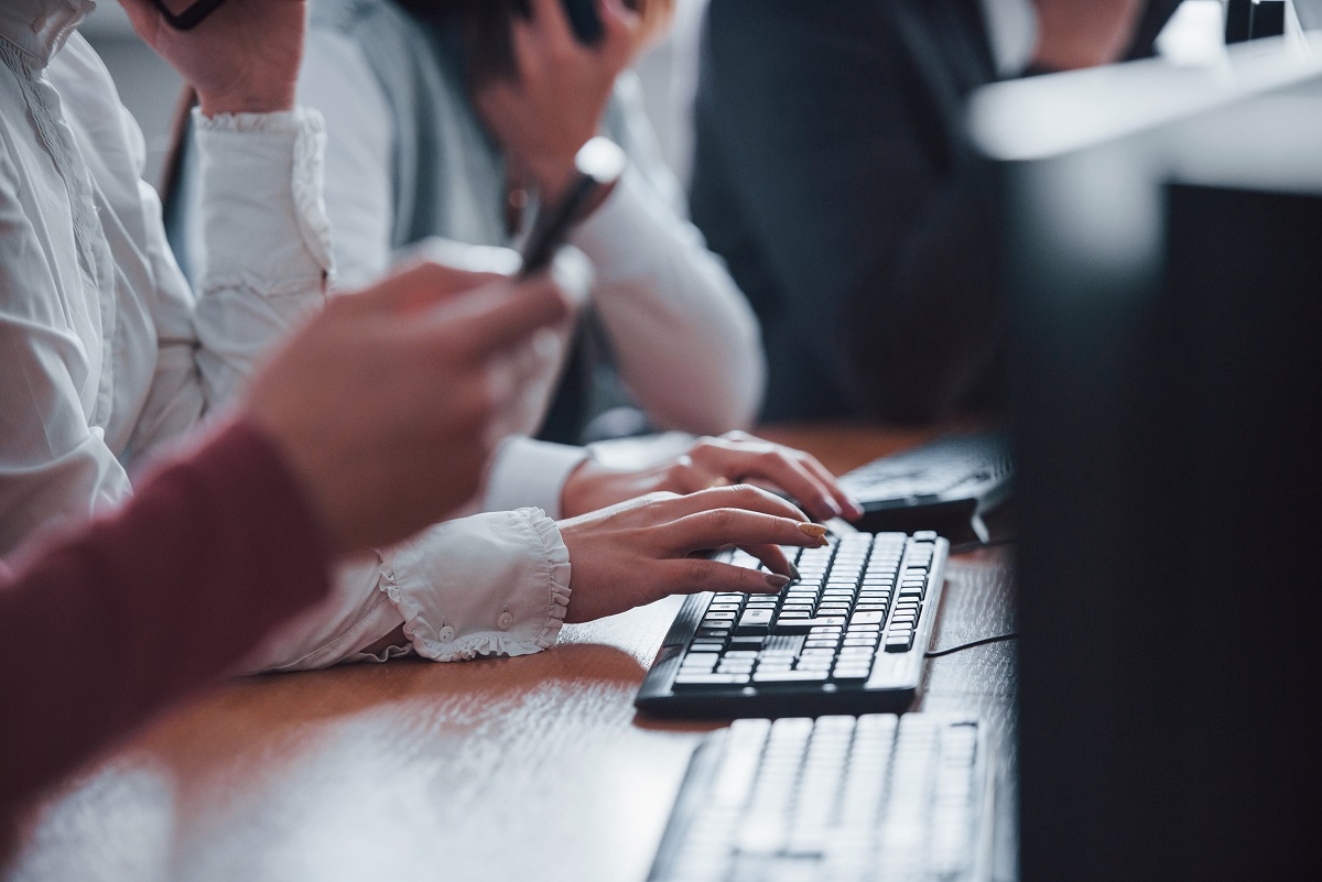 Close up view of woman's hands typing on keyboard. Young people working in the call center. New deals is coming.